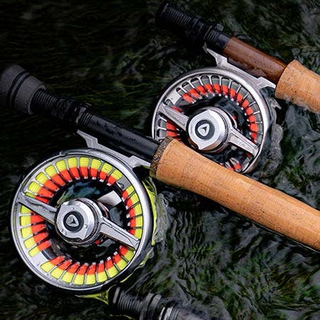 Close up of several fly reels in the river water