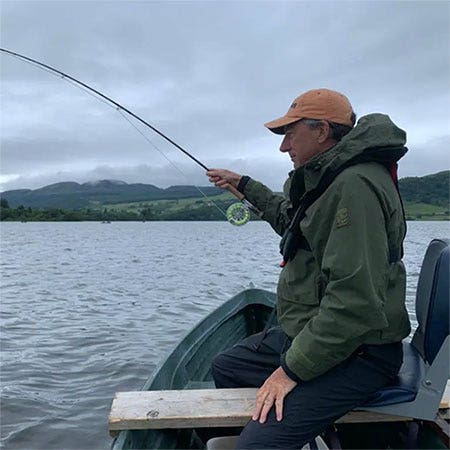 Fly fishing from a boat on a reservoir with dry flies