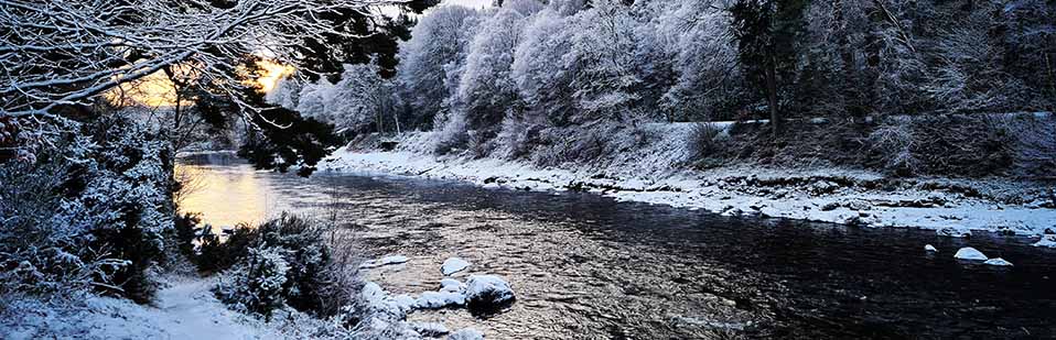 Christmas Gift Ideas from Sportfish for Anglers and Fishermen Beautiful Snowy River Scene with Sun Poking Through, representing Christmas Gift Ideas
