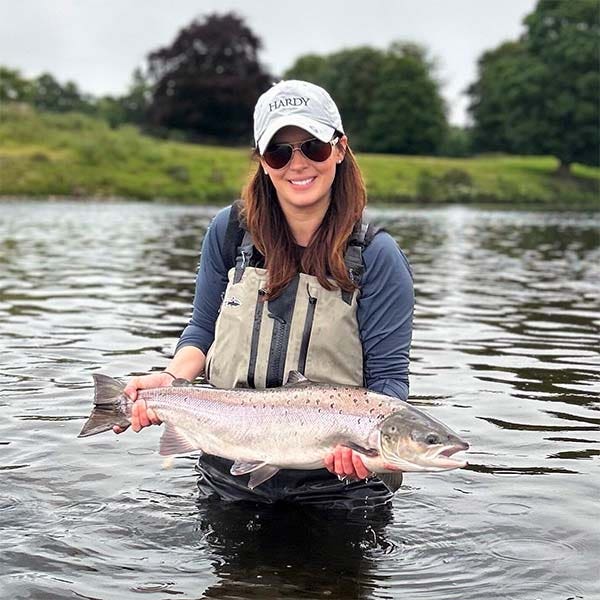 Lucy pictured holding her salmon up