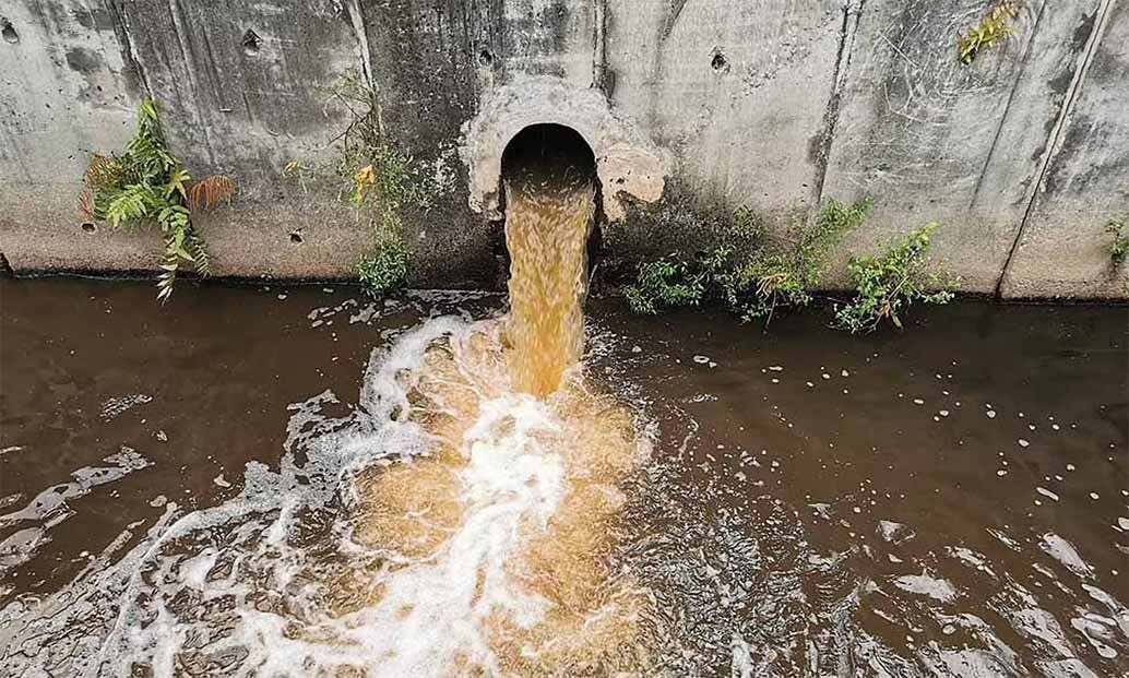 Raw sewage flowing into a river Raw sewage flowing into a river